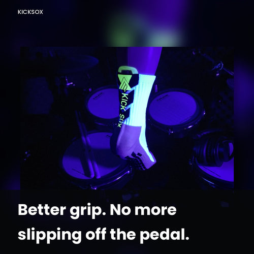 Drummer wearing a glow-in-the-dark KickSox sock on the kick pedal foot under blacklight for better grip